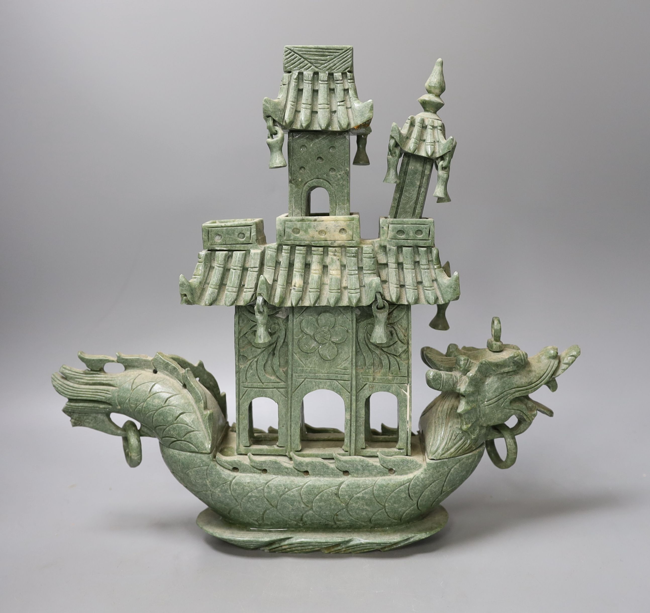 A Chinese hardstone intricately carved model of a boat, with inscription on the flag - 31cm tall